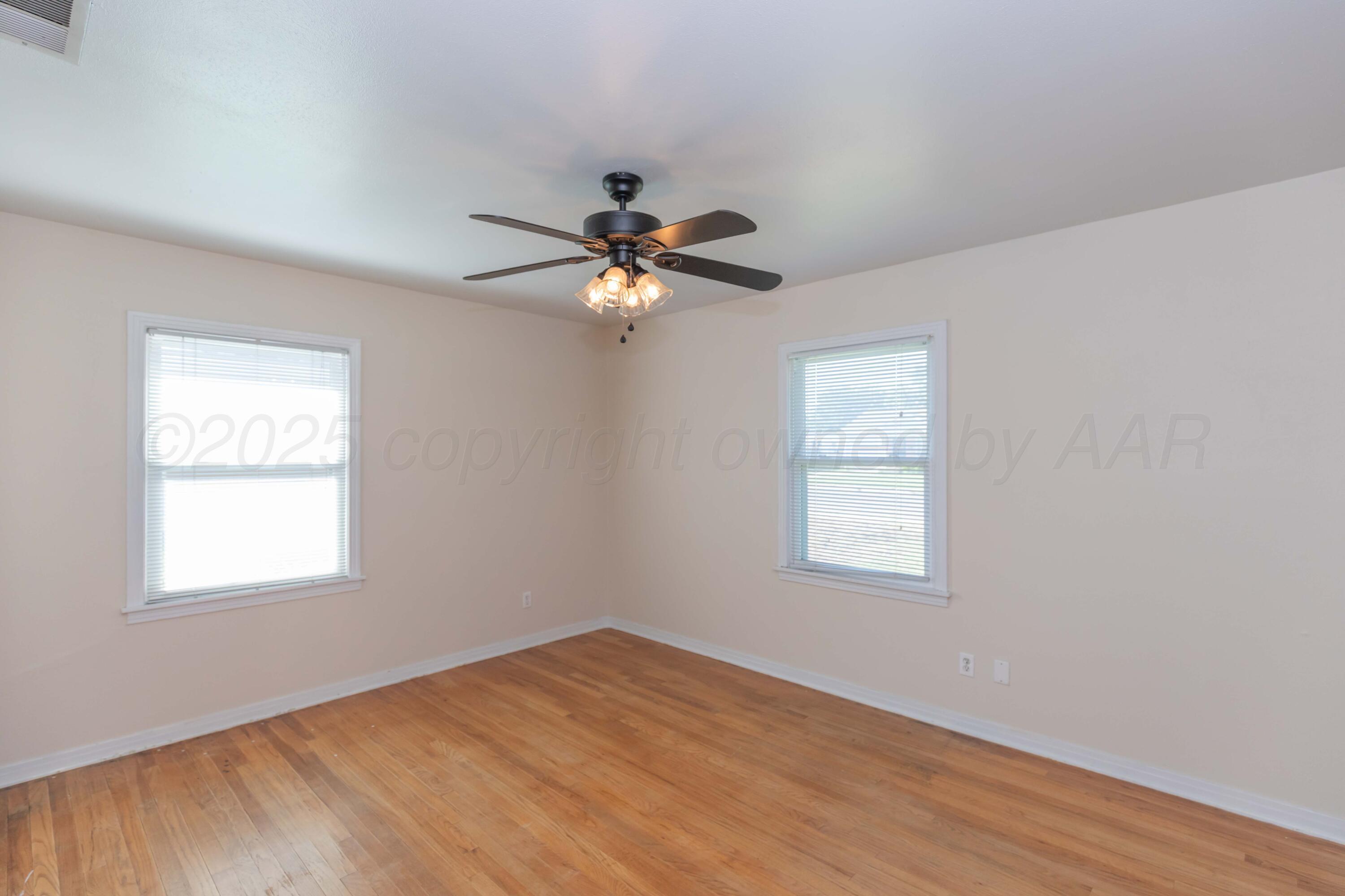 3513 Concord Road Amarillo, TX 79109 - Photo 17 of 45 a view of an empty room with wooden floor and a window