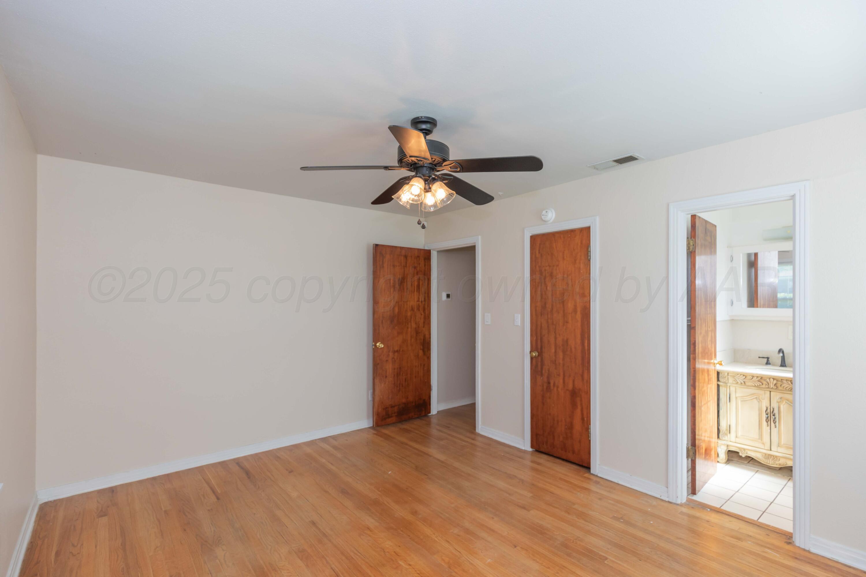 3513 Concord Road Amarillo, TX 79109 - Photo 19 of 45 a light room with closet and ceiling fan