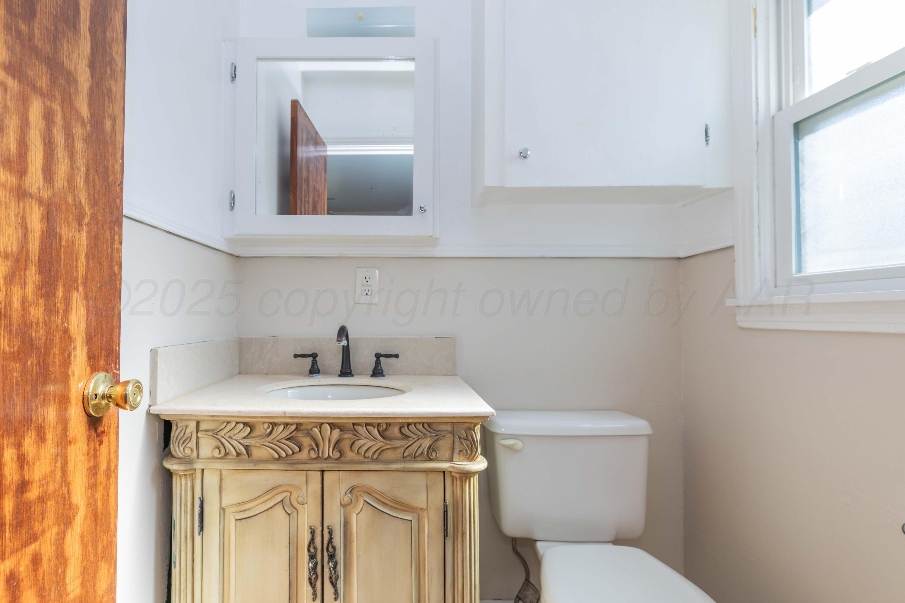 3513 Concord Road Amarillo, TX 79109 - Photo 22 of 45 a bathroom with a sink vanity and toilet