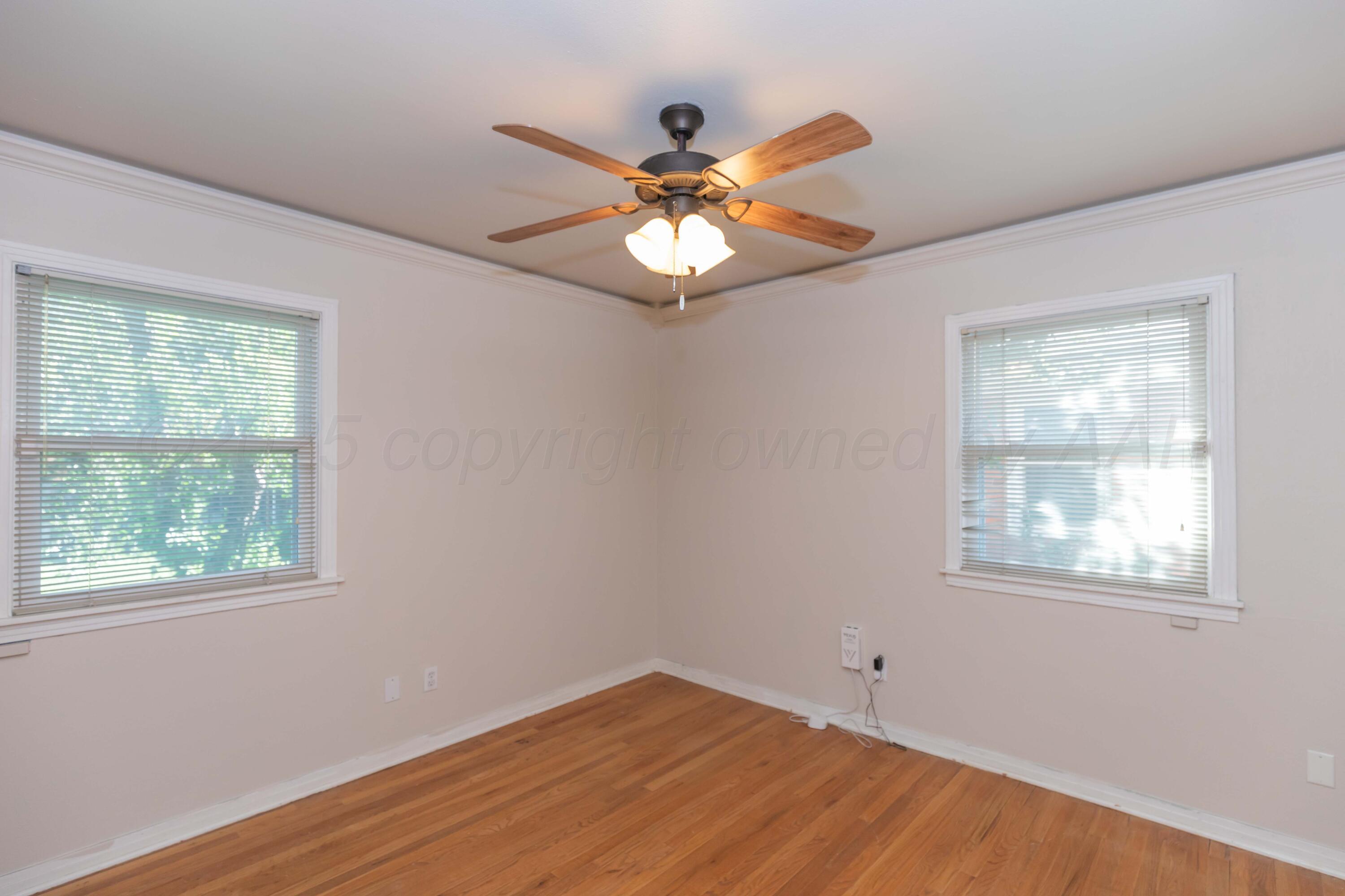 3513 Concord Road Amarillo, TX 79109 - Photo 25 of 45 a view of an empty room with wooden floor and a window
