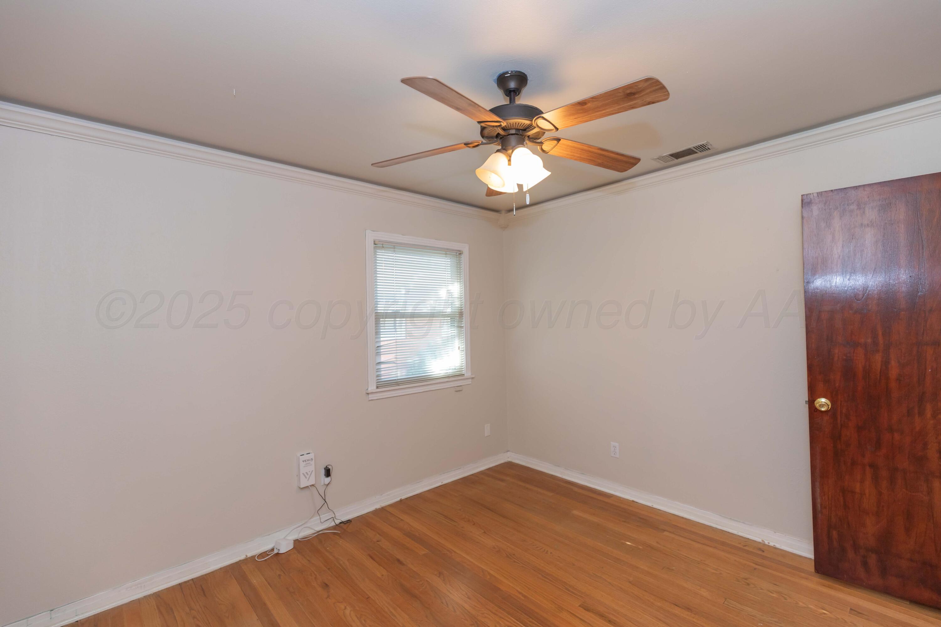 3513 Concord Road Amarillo, TX 79109 - Photo 28 of 45 a view of an empty room with wooden floor and a window