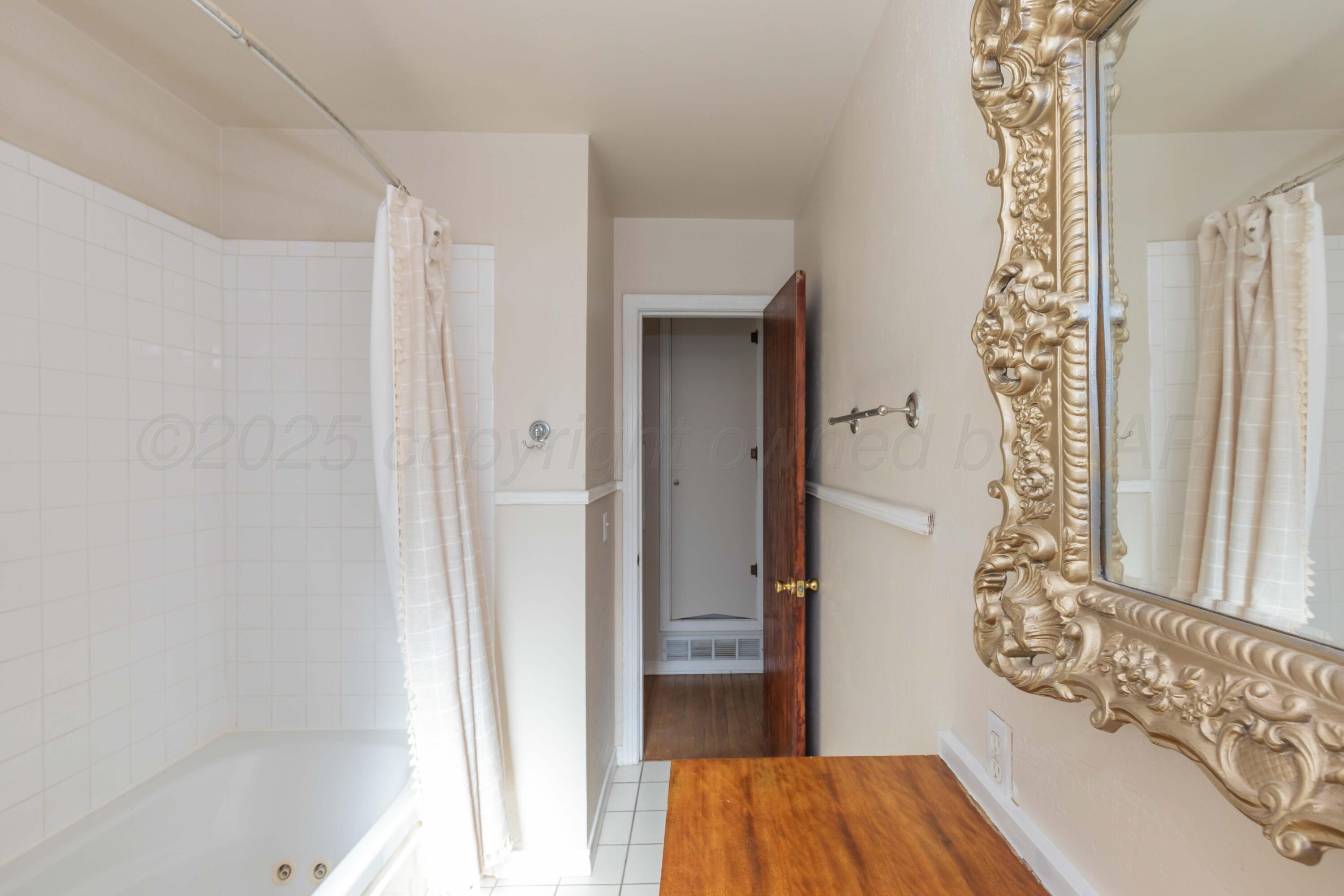 3513 Concord Road Amarillo, TX 79109 - Photo 30 of 45 a very nice looking room with a wooden floor and a shower