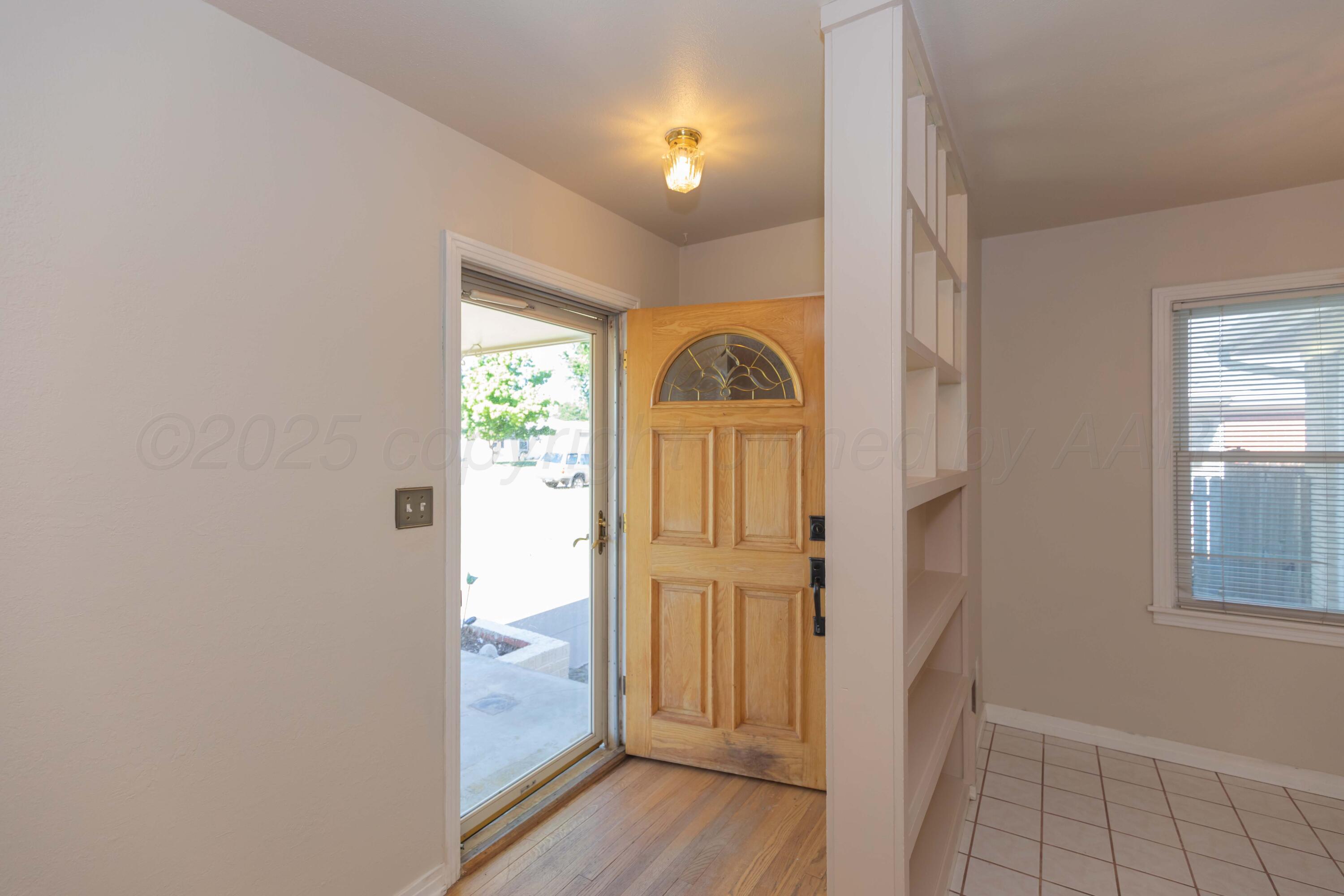 3513 Concord Road Amarillo, TX 79109 - Photo 3 of 45 a view of empty room with wooden floor and window
