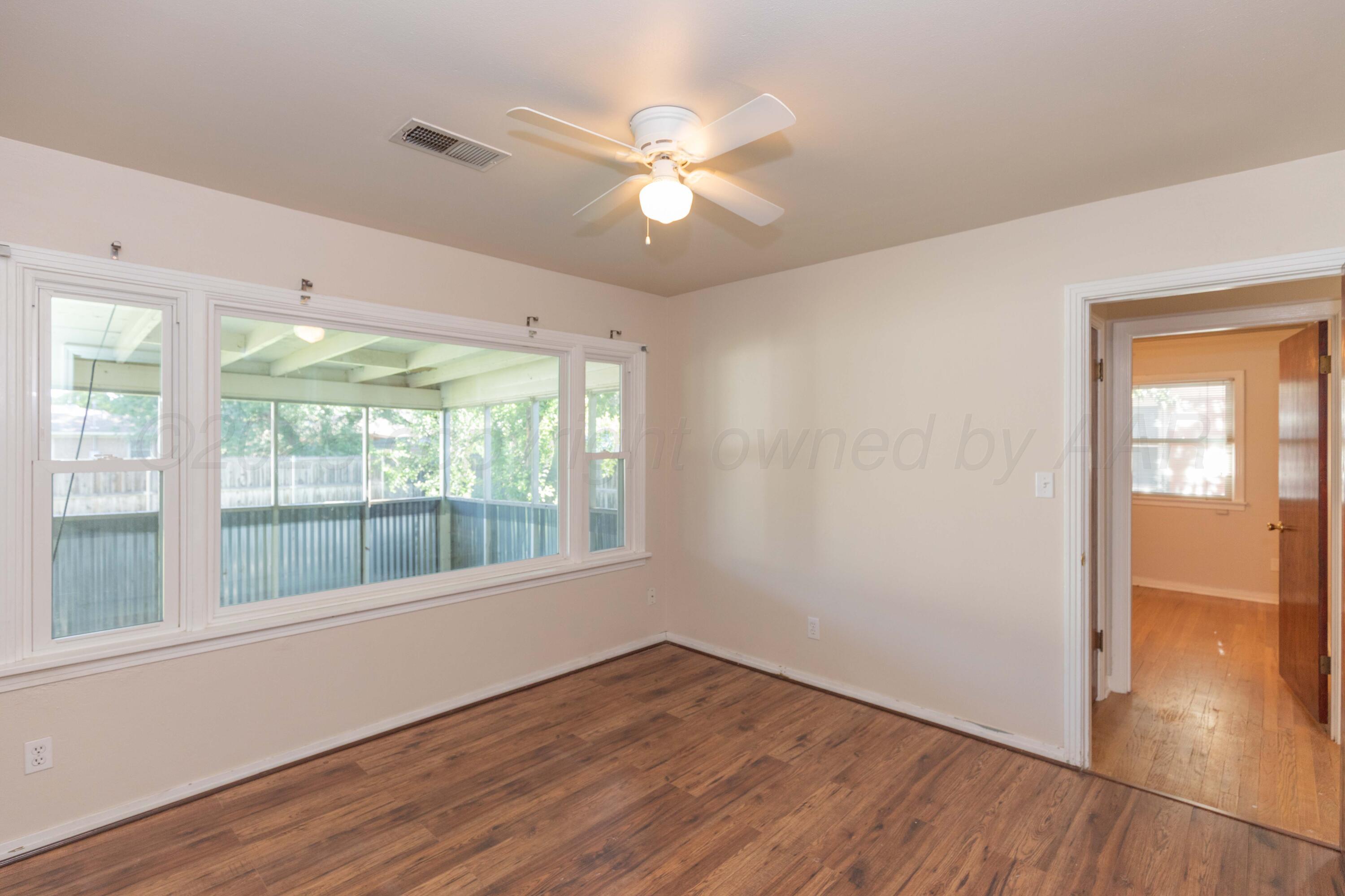 3513 Concord Road Amarillo, TX 79109 - Photo 32 of 45 a view of an empty room with wooden floor and a window