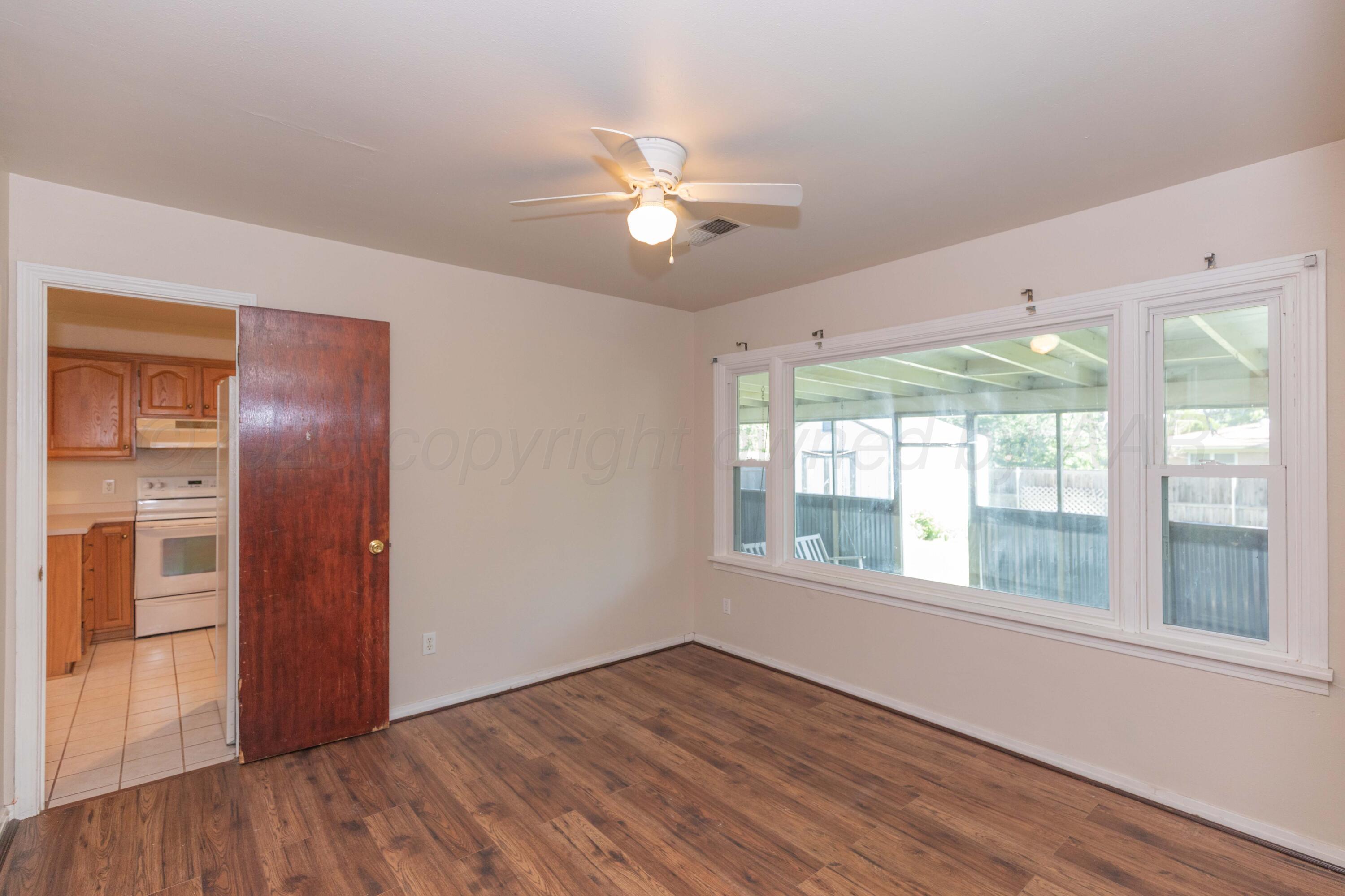 3513 Concord Road Amarillo, TX 79109 - Photo 35 of 45 a view of an empty room with a window and wooden floor