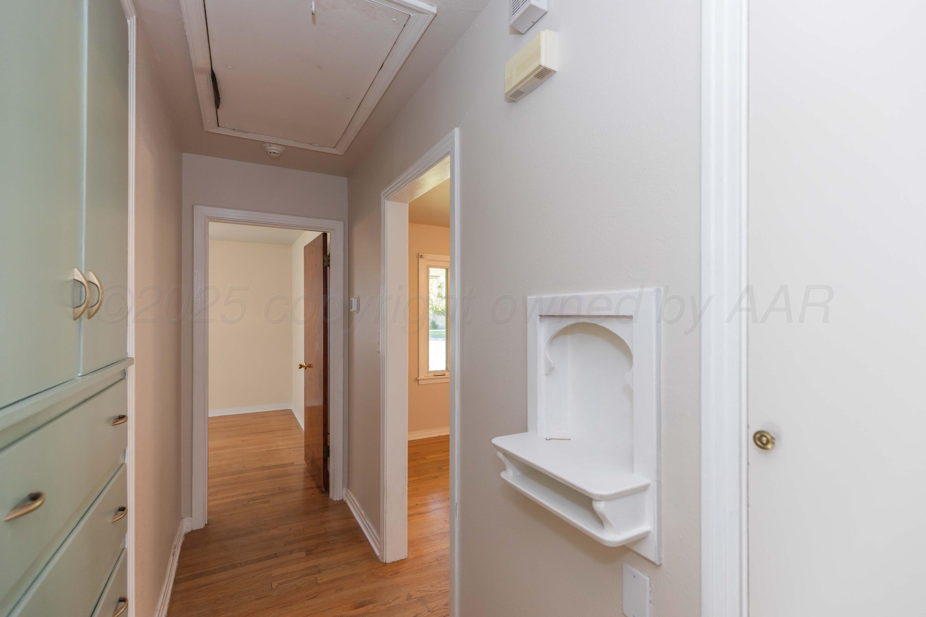3513 Concord Road Amarillo, TX 79109 - Photo 36 of 45 a room with wooden floor and a bathroom