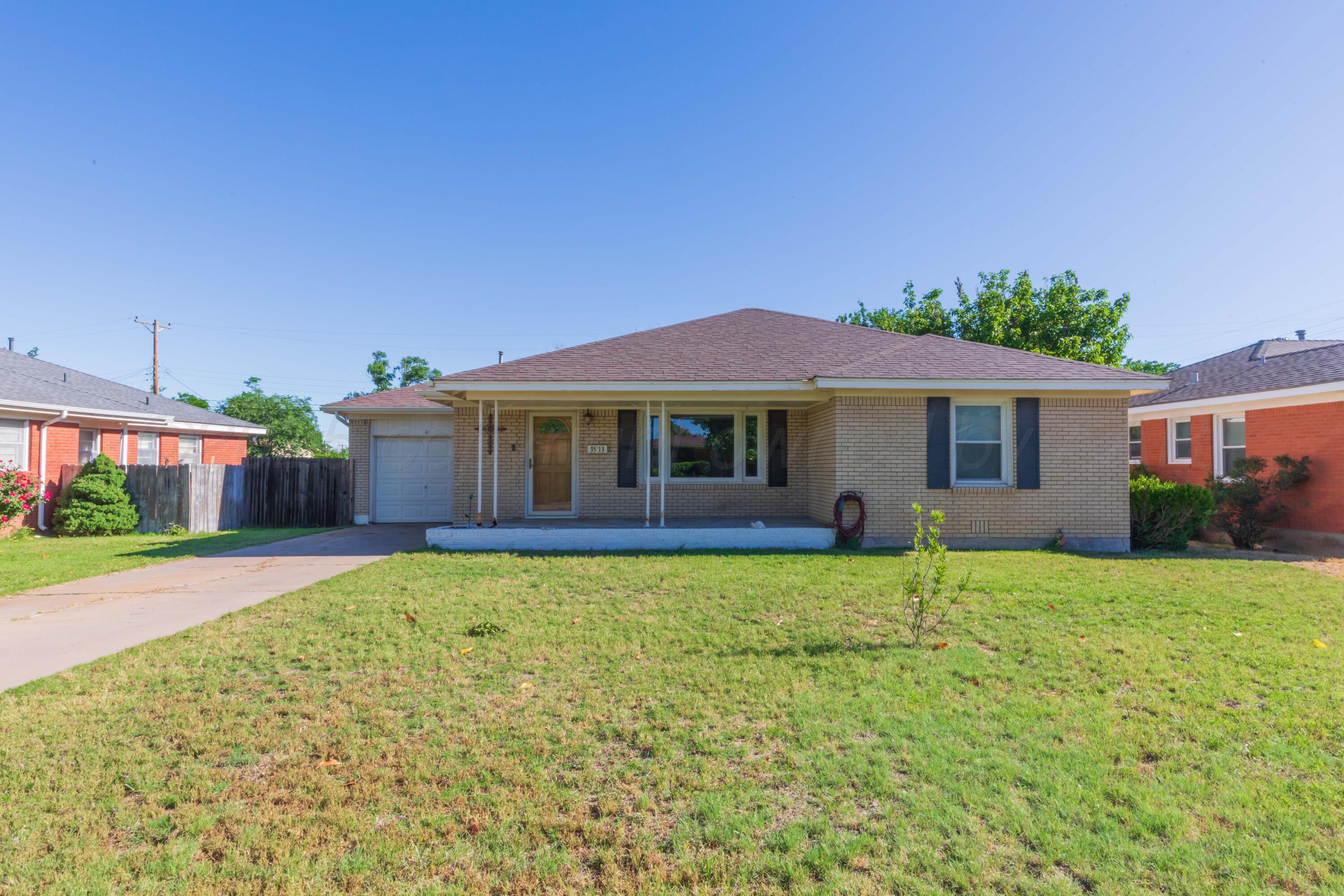 3513 Concord Road Amarillo, TX 79109 - Photo 45 of 45 a front view of a house with a garden and yard
