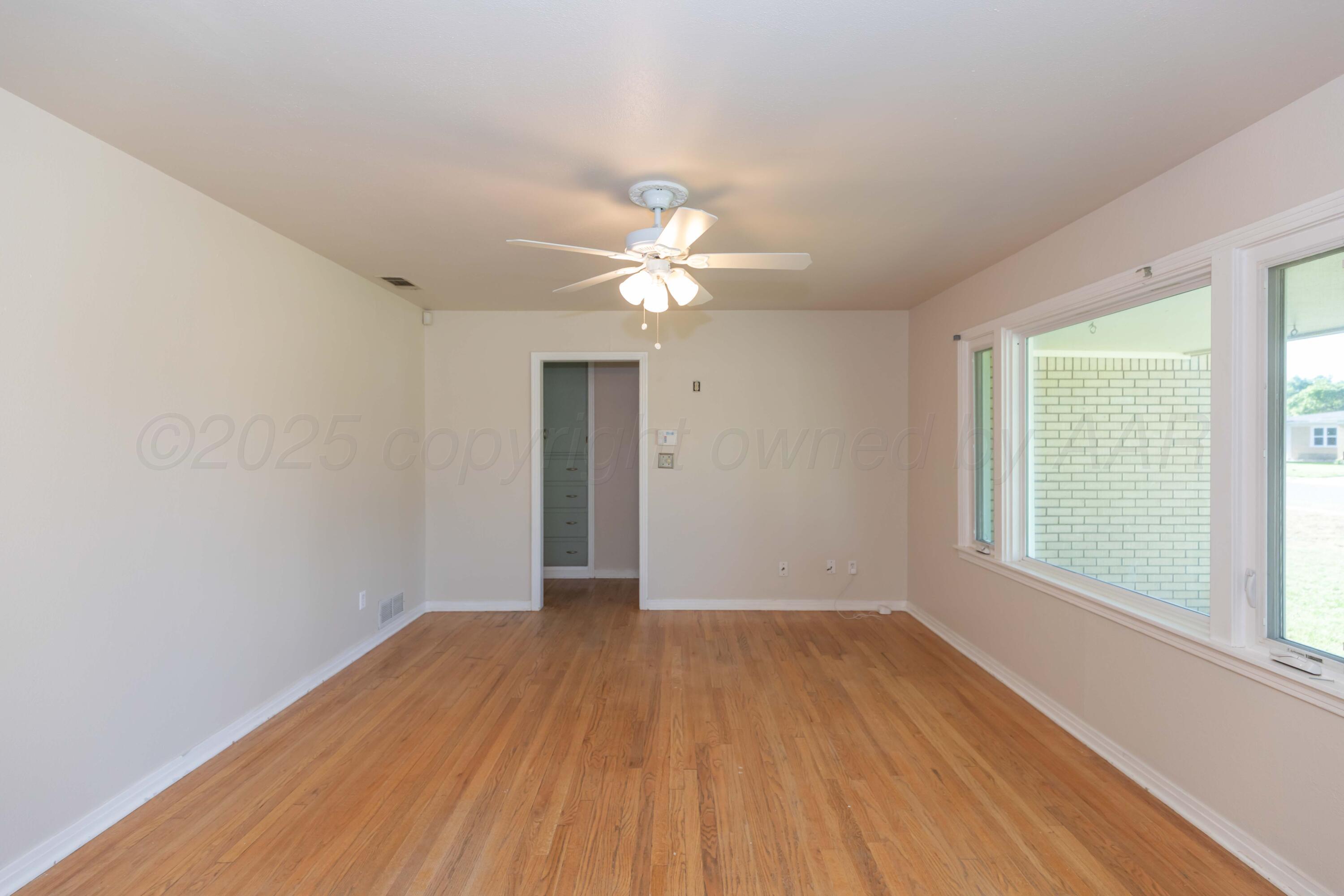 3513 Concord Road Amarillo, TX 79109 - Photo 5 of 45 wooden floor in an empty room with a window