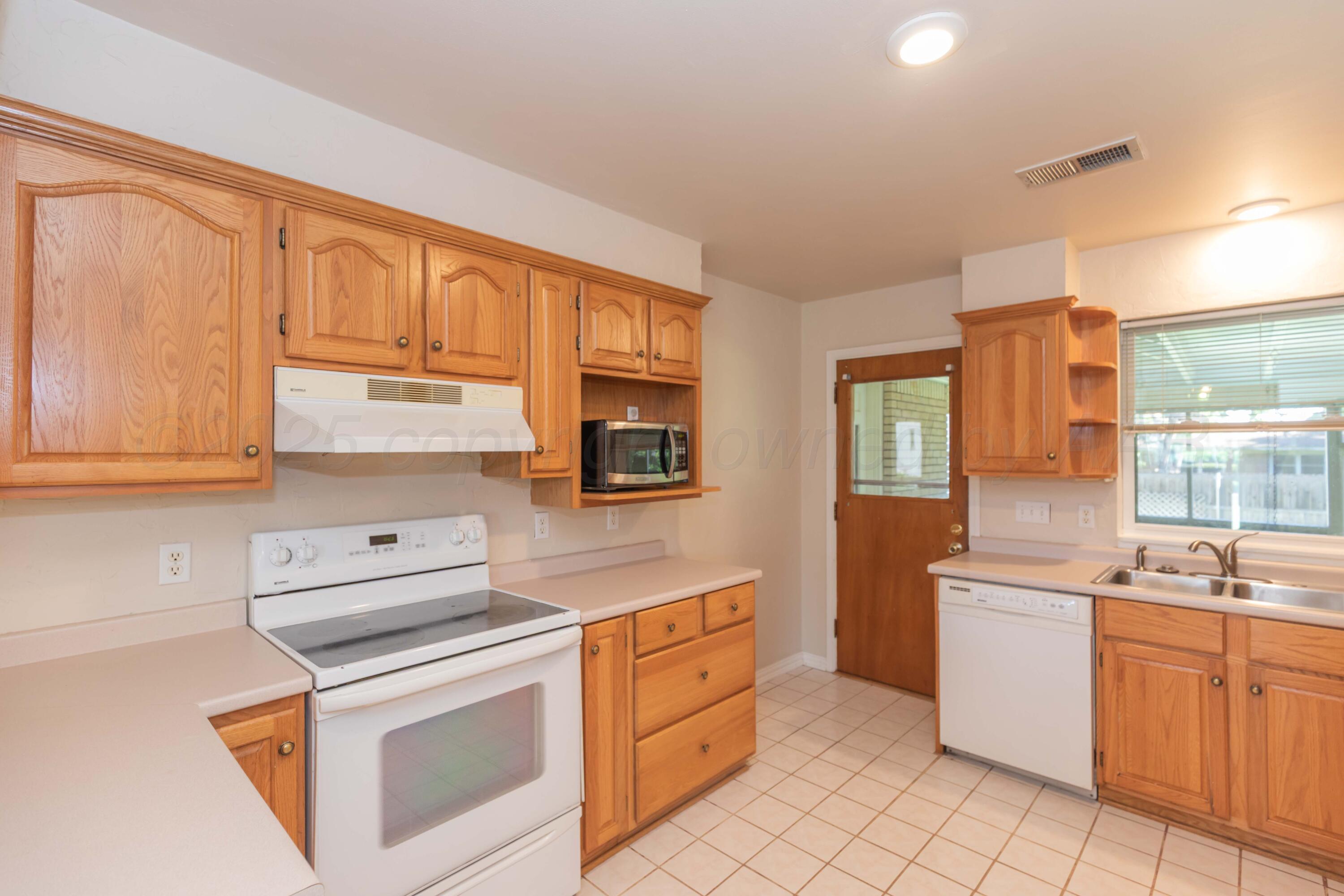 3513 Concord Road Amarillo, TX 79109 - Photo 9 of 45 a kitchen with appliances cabinets and a sink