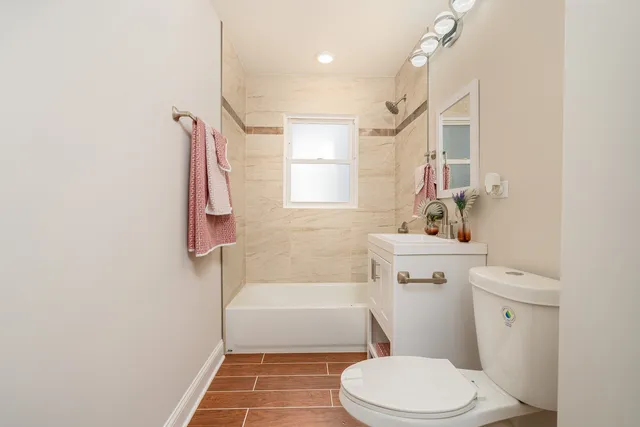 a bathroom with a toilet a sink and bathtub