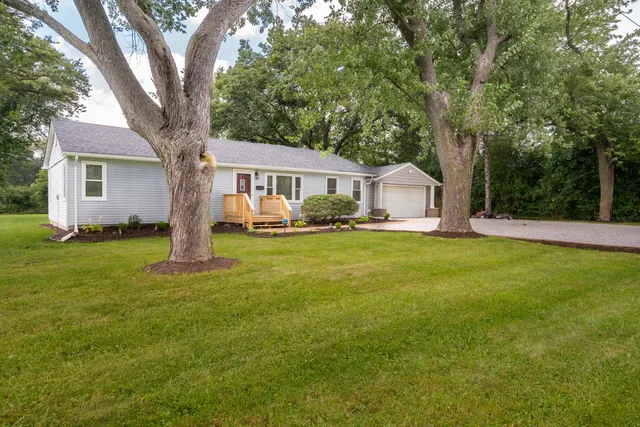 a front view of house with yard and green space