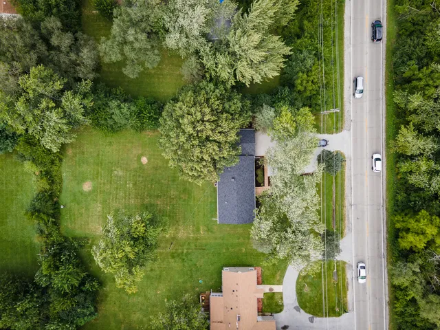 an aerial view of a house with a yard