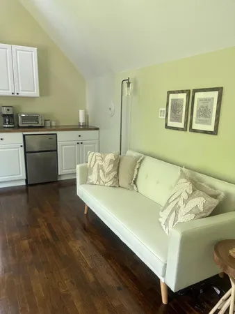 a living room with furniture and kitchen view