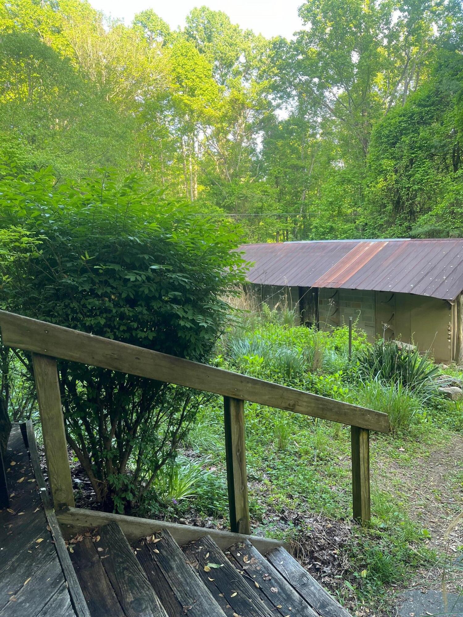 9737 Pine Forest Road Northeast Copper Hill, VA 24079 - Photo 34 of 41 a view of a wooden deck next to a yard
