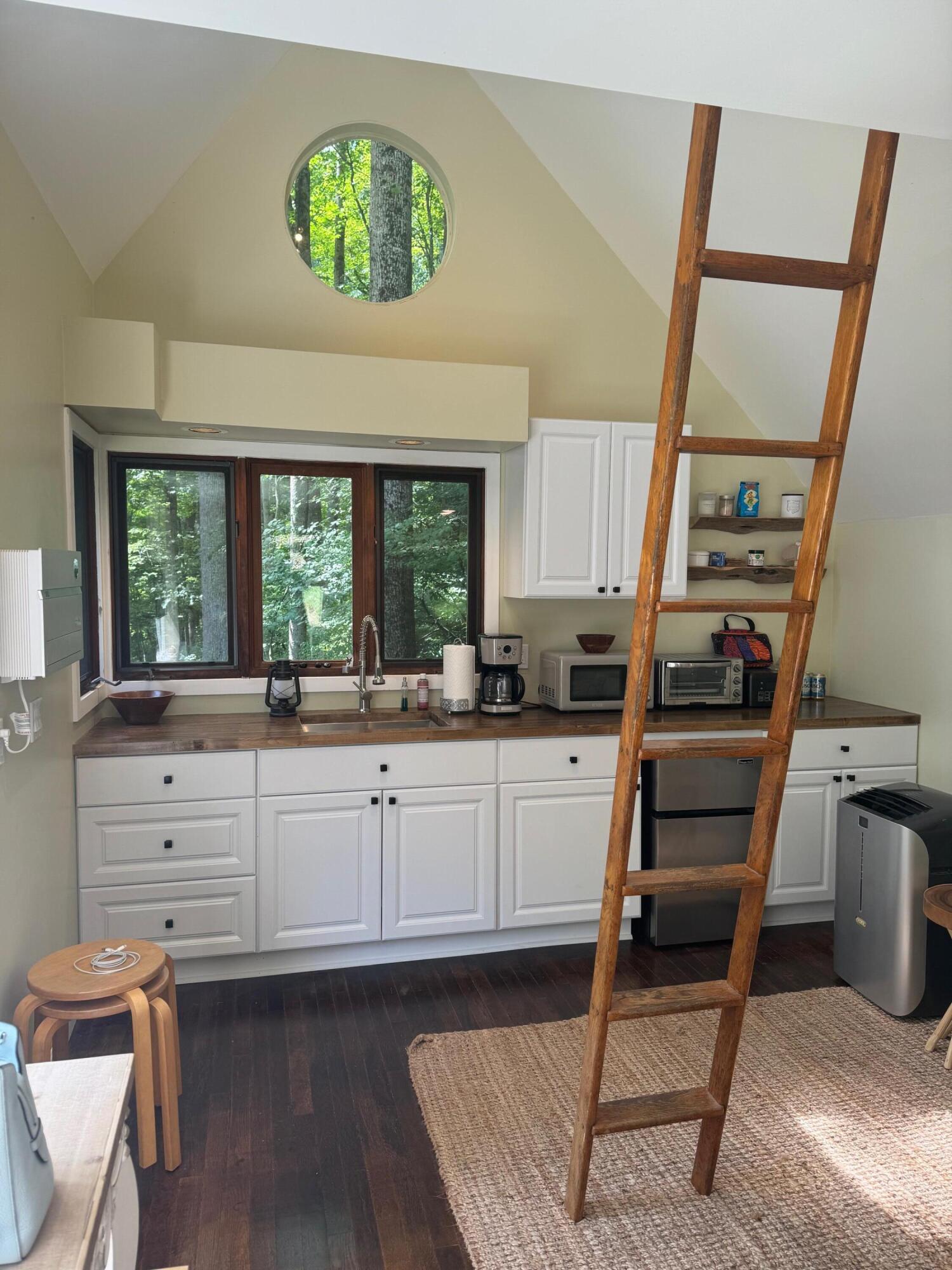 9737 Pine Forest Road Northeast Copper Hill, VA 24079 - Photo 6 of 41 a kitchen with white cabinets and window