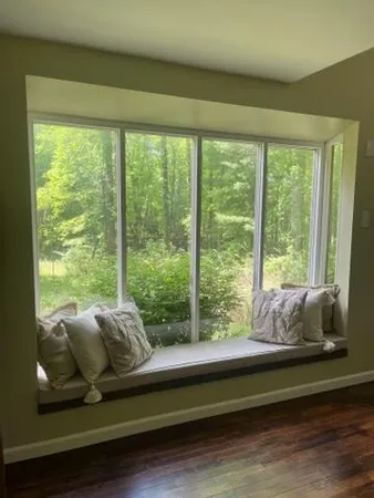 a living room with couch and windows