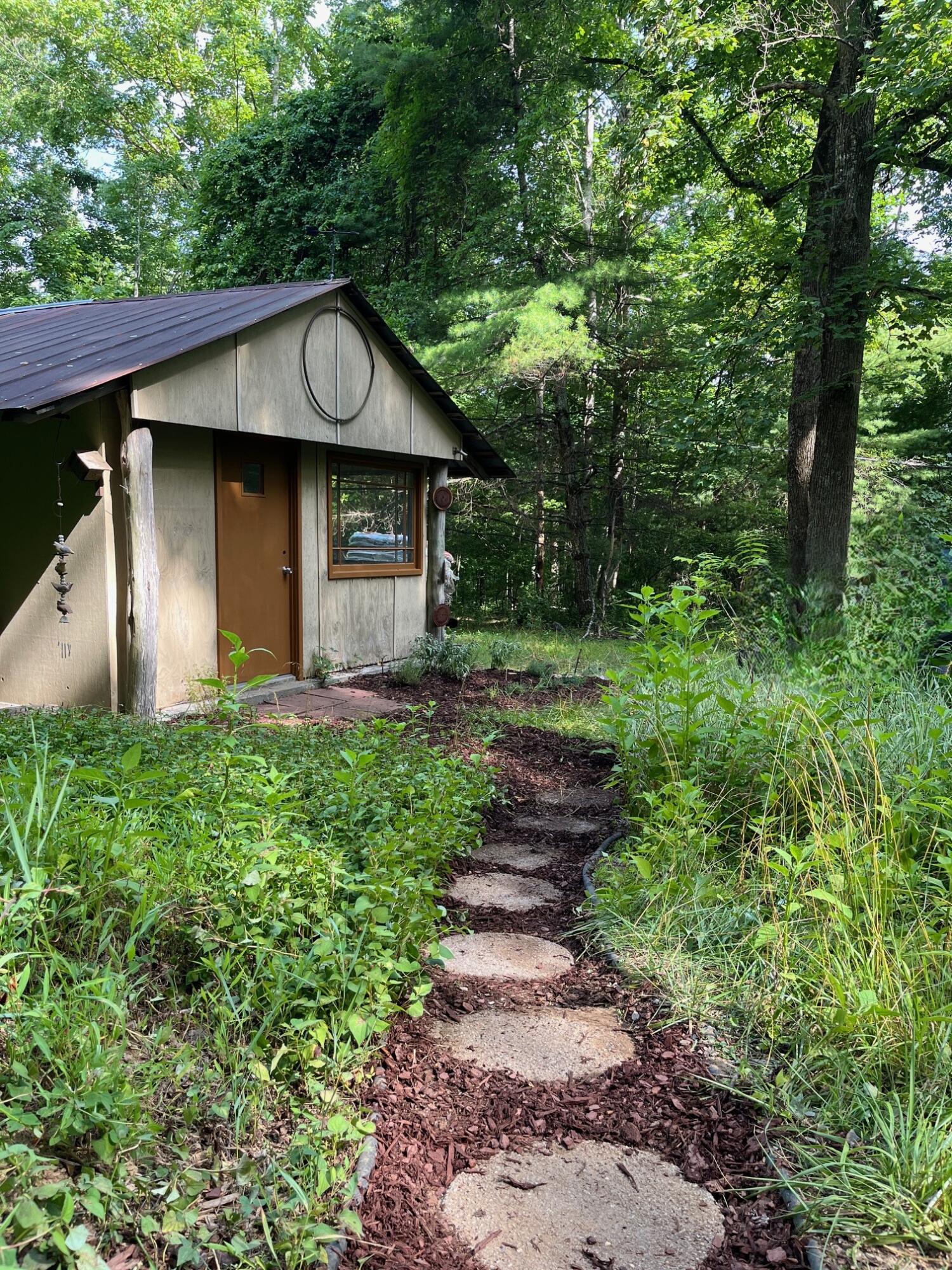 9737 Pine Forest Road Northeast Copper Hill, VA 24079 - Photo 10 of 41 a front view of a house with garden