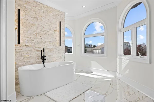 a bathroom with a granite countertop shower a sink and vanity