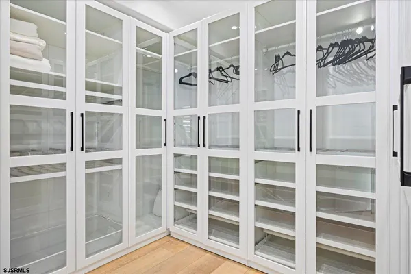 a spacious bathroom with a double vanity sink a mirror and shower