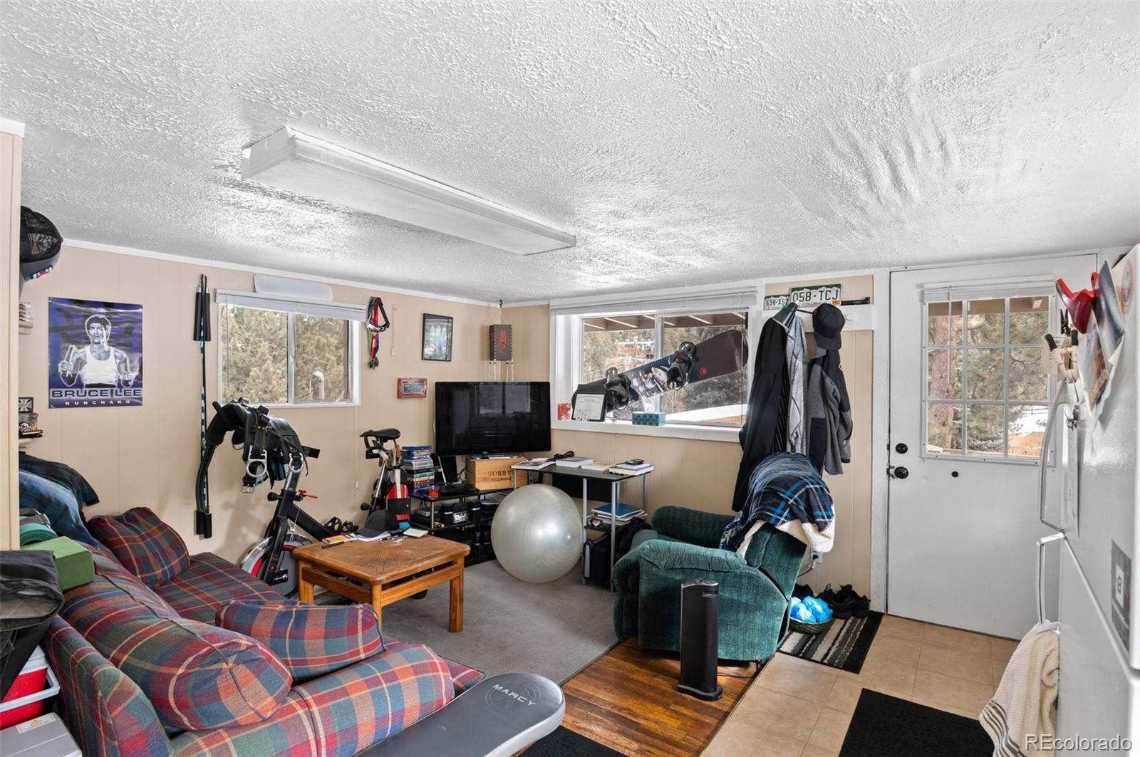 4997 Camel Heights Road Evergreen, CO 80439 - Photo 11 of 24 a living room with furniture and a flat screen tv