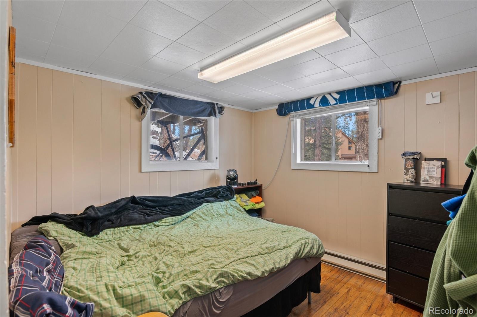 4997 Camel Heights Road Evergreen, CO 80439 - Photo 12 of 24 a bed sitting in a bedroom next to a window