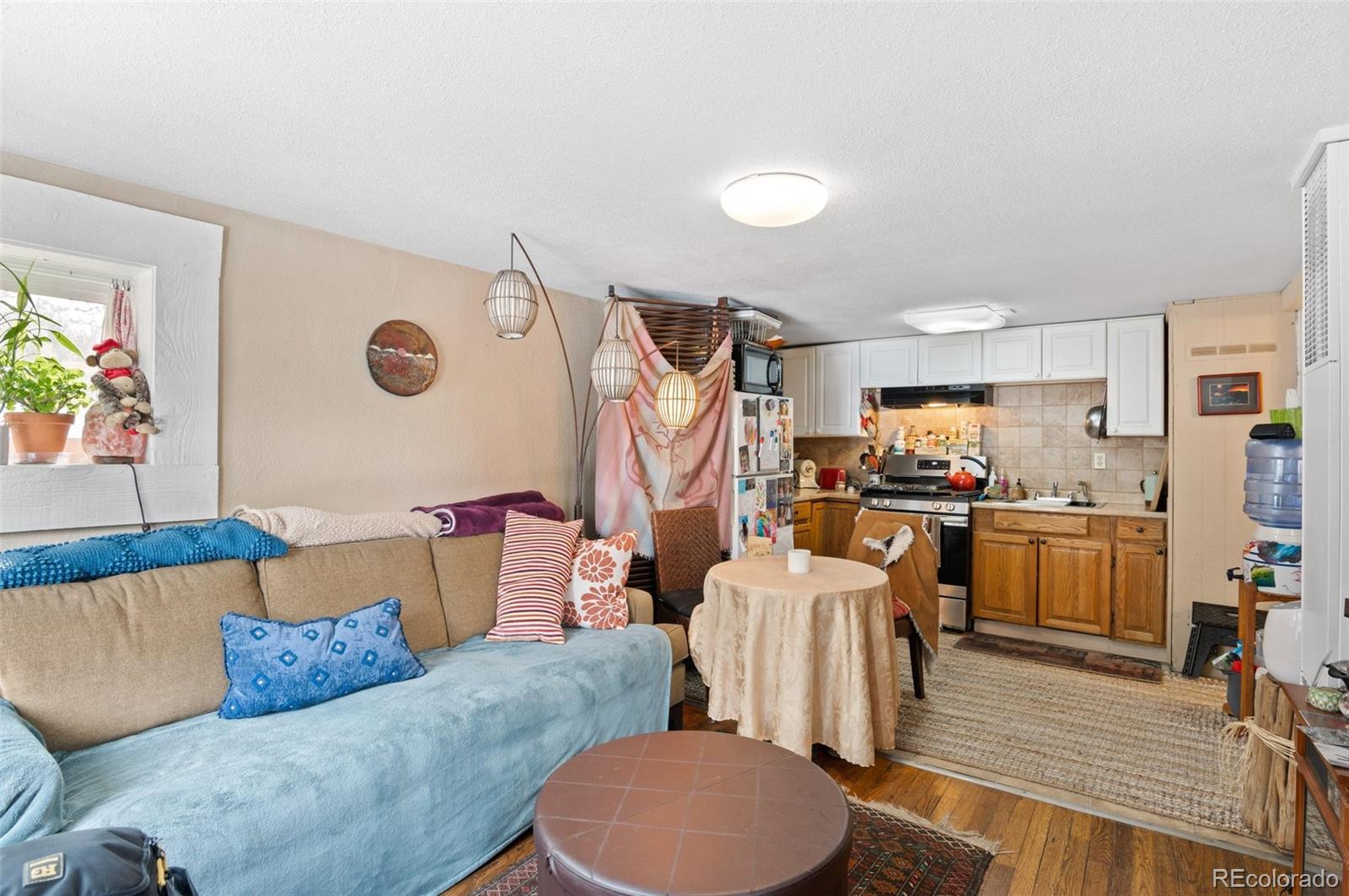 4997 Camel Heights Road Evergreen, CO 80439 - Photo 16 of 24 a living room with furniture and a flat screen tv