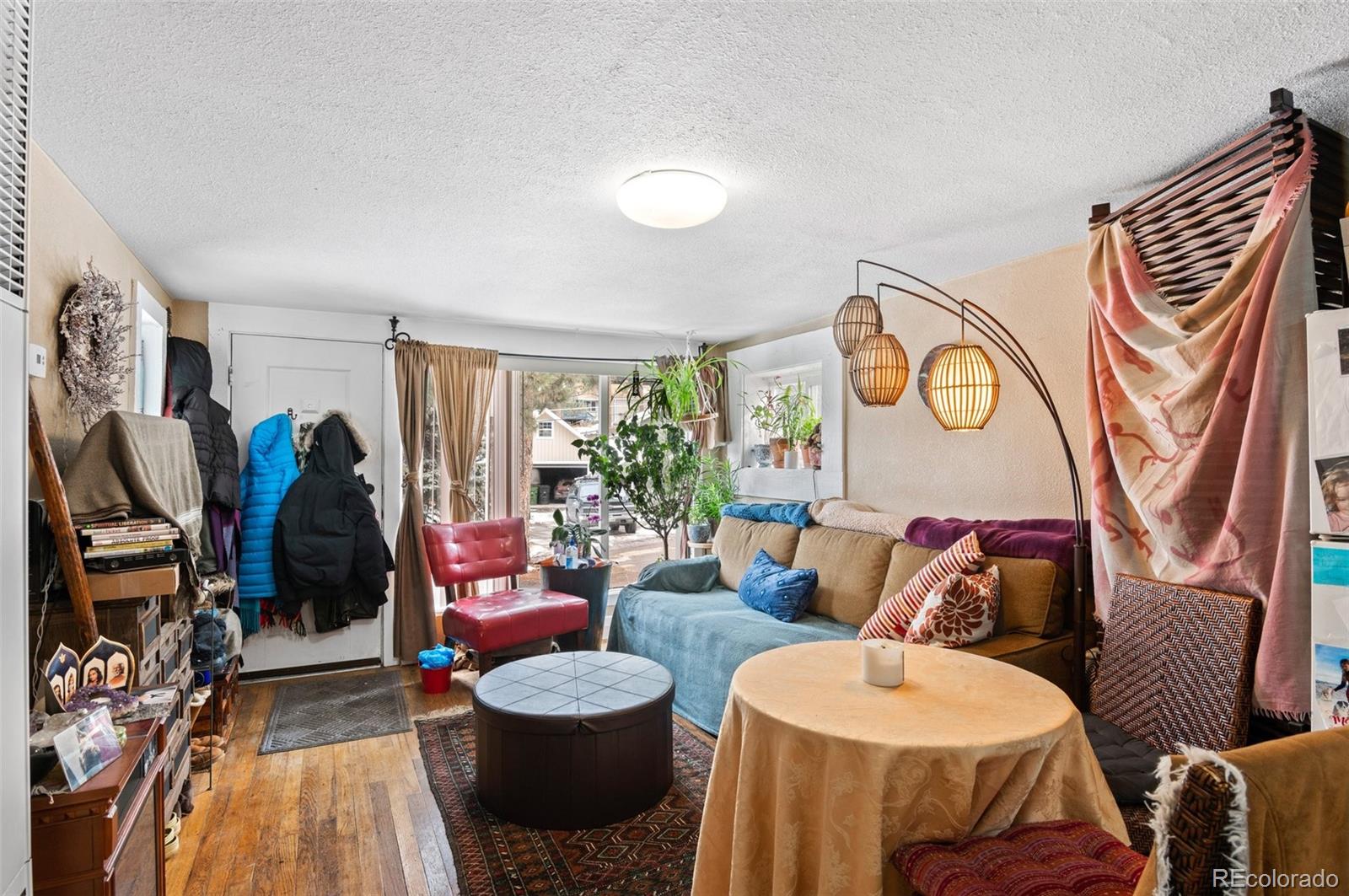 4997 Camel Heights Road Evergreen, CO 80439 - Photo 17 of 24 a living room with furniture a rug and a window