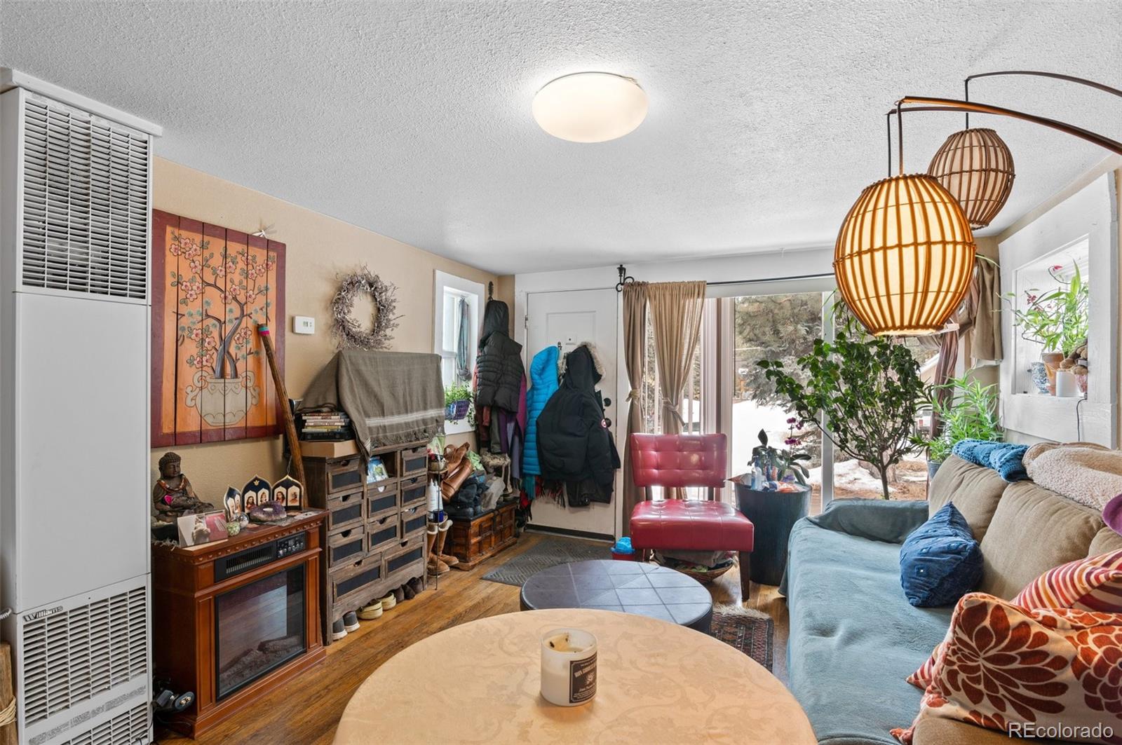 4997 Camel Heights Road Evergreen, CO 80439 - Photo 18 of 24 a living room with furniture a window and gym equipment
