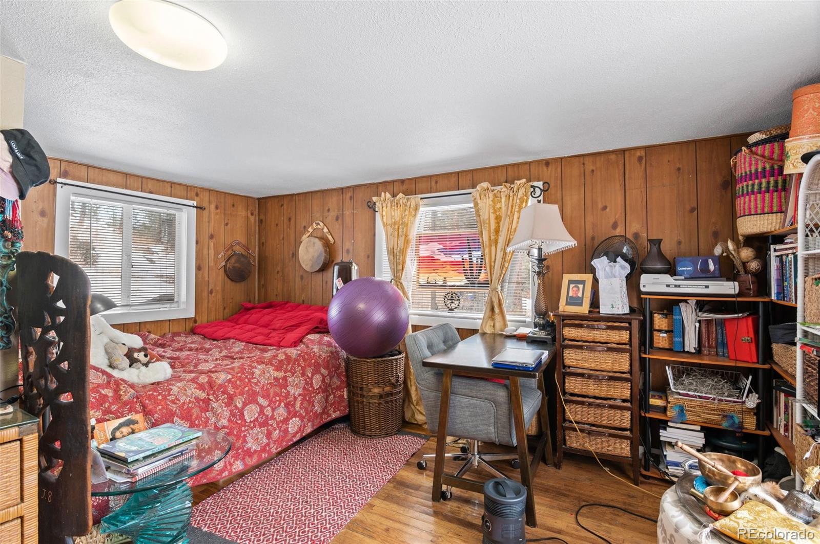 4997 Camel Heights Road Evergreen, CO 80439 - Photo 21 of 24 a bedroom with furniture and a closet