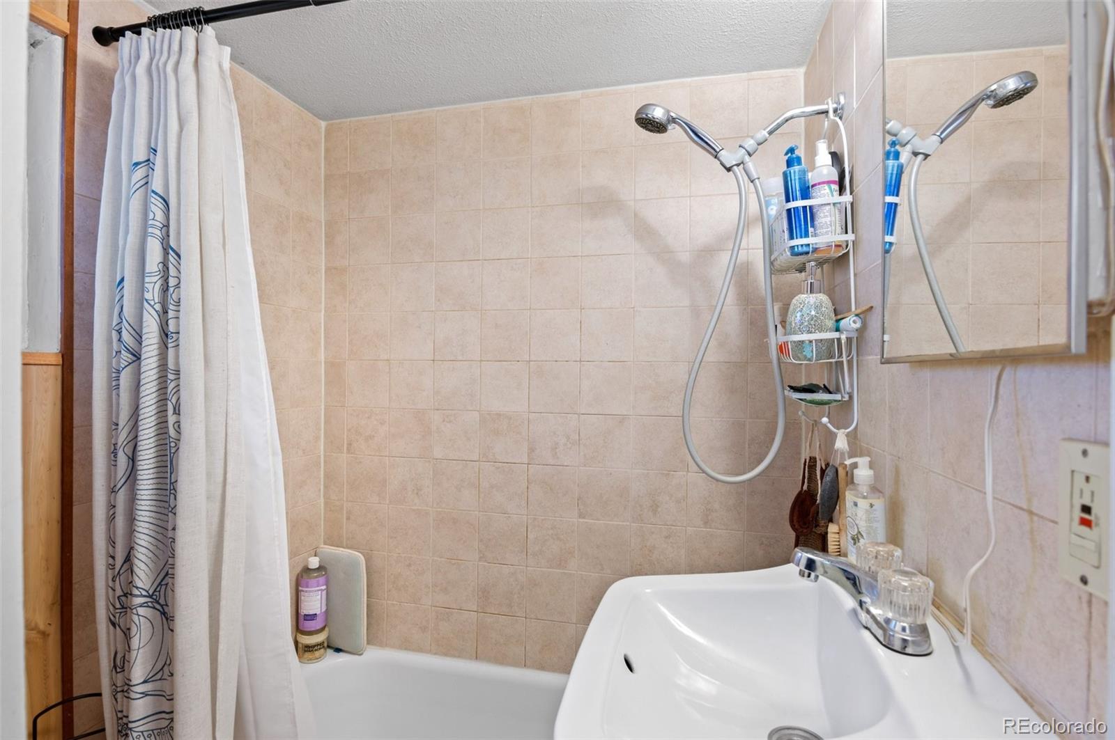 4997 Camel Heights Road Evergreen, CO 80439 - Photo 23 of 24 a bathroom with a sink a toilet and shower