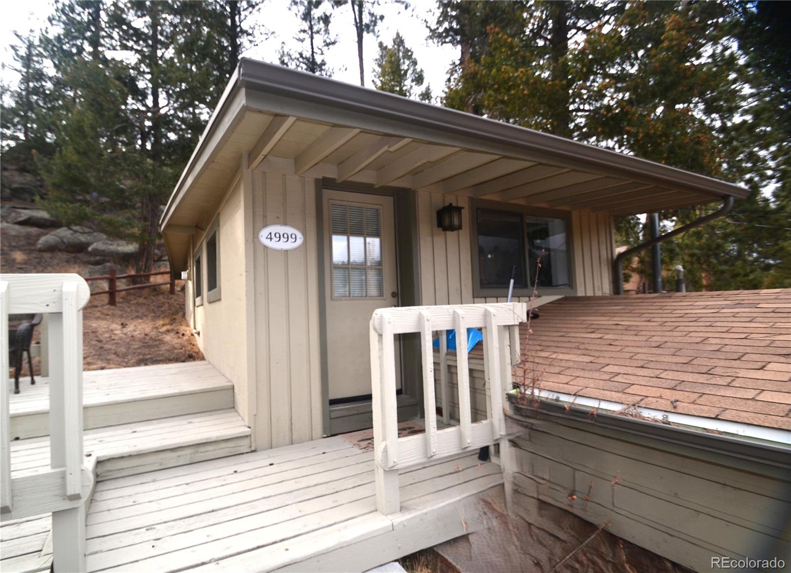4997 Camel Heights Road Evergreen, CO 80439 - Photo 3 of 24 a front view of house with yard