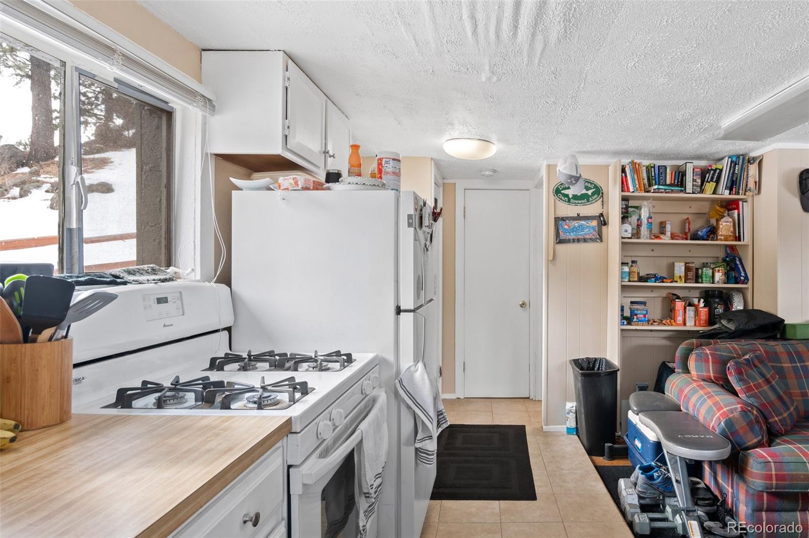 4997 Camel Heights Road Evergreen, CO 80439 - Photo 4 of 24 a kitchen with a refrigerator and a stove