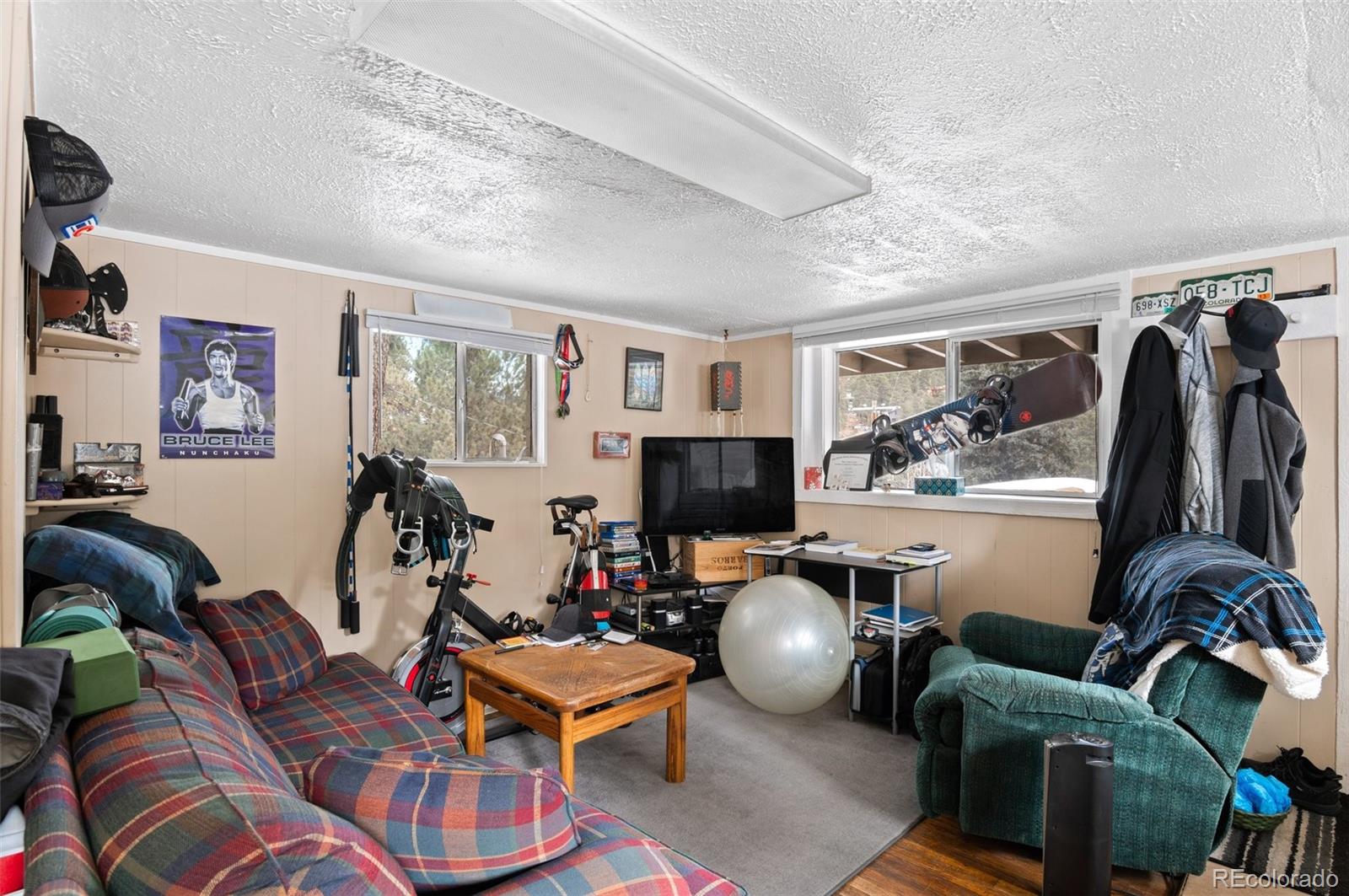 4997 Camel Heights Road Evergreen, CO 80439 - Photo 6 of 24 a living room with furniture a flat screen tv and a window