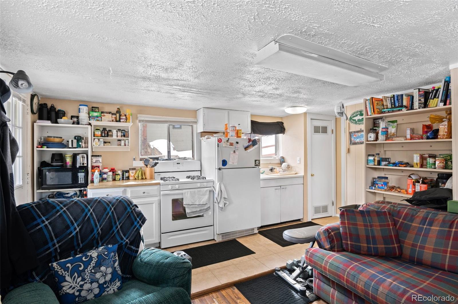 4997 Camel Heights Road Evergreen, CO 80439 - Photo 7 of 24 a living room with furniture and a book shelf