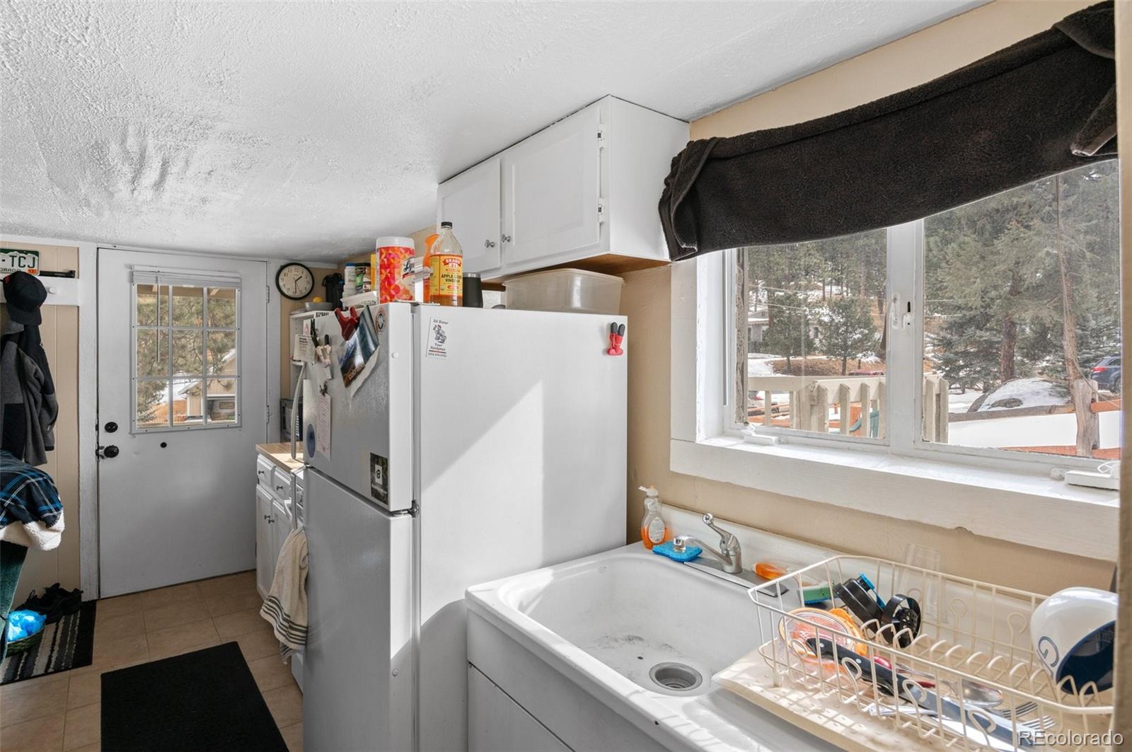 4997 Camel Heights Road Evergreen, CO 80439 - Photo 10 of 24 a white refrigerator freezer sitting inside of a kitchen