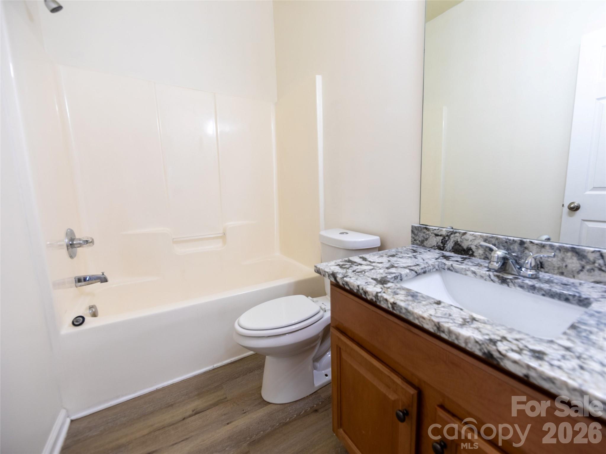 6002 Brook Valley Run Monroe, NC 28110 - Photo 18 of 32 a bathroom with a granite countertop sink toilet and shower