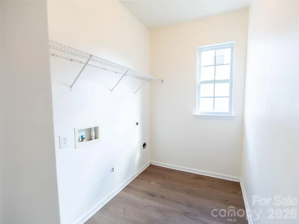 an empty room with a windows and cabinet