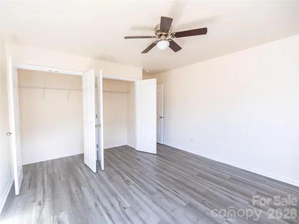 a view of a room with wooden floor