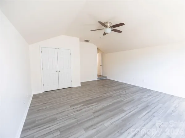 a view of a room with wooden floor