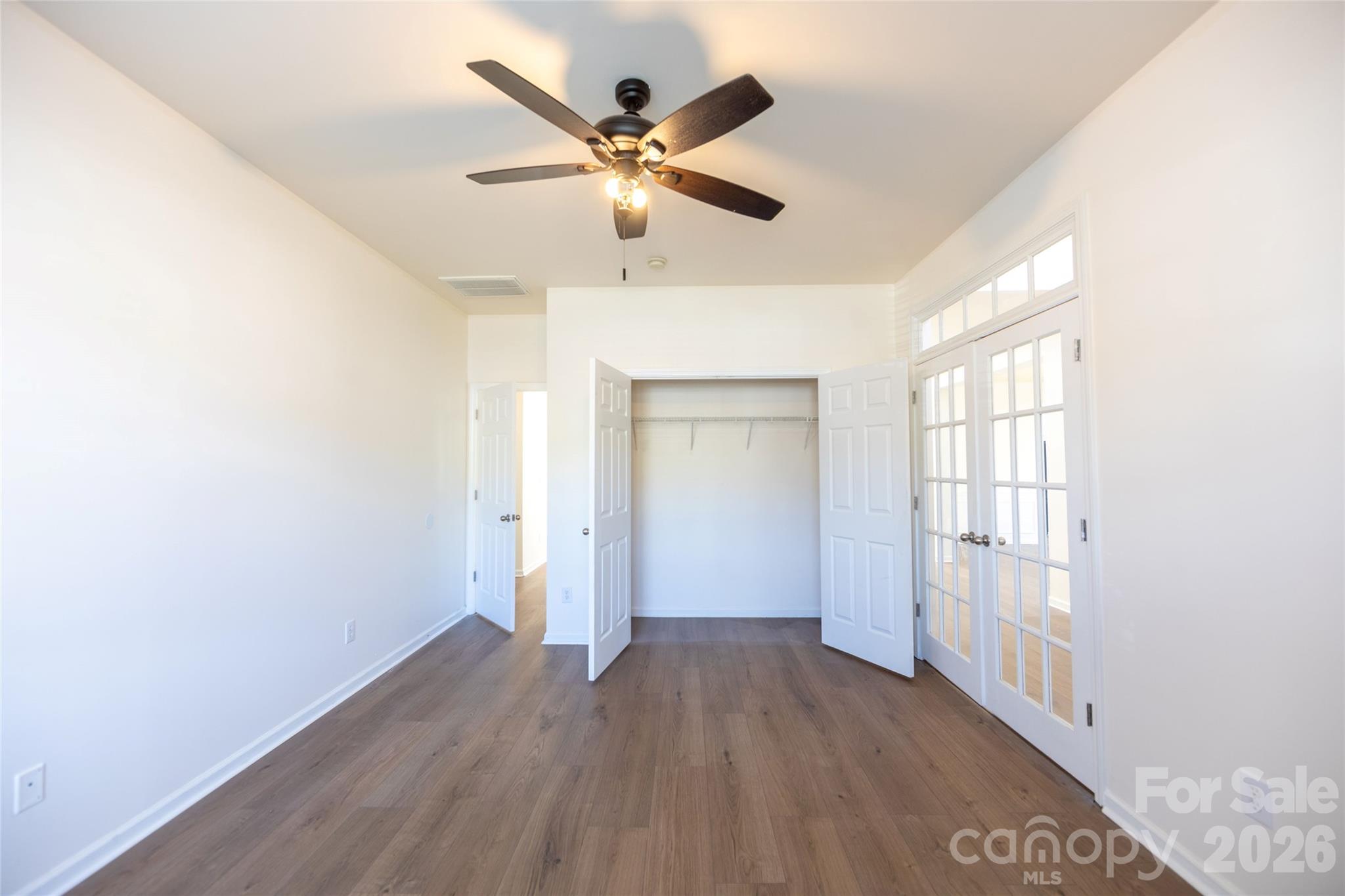 6002 Brook Valley Run Monroe, NC 28110 - Photo 3 of 32 an empty room with wooden floor and windows