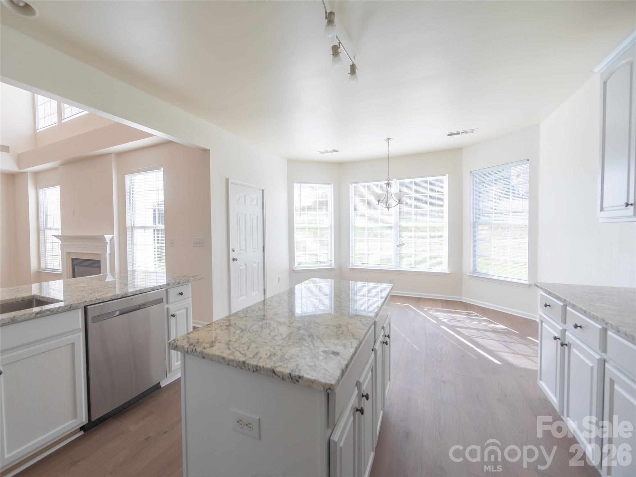 6002 Brook Valley Run Monroe, NC 28110 - Photo 31 of 32 a large kitchen with kitchen island granite countertop a large window