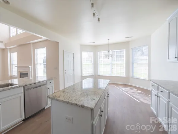 a large kitchen with kitchen island granite countertop a large window