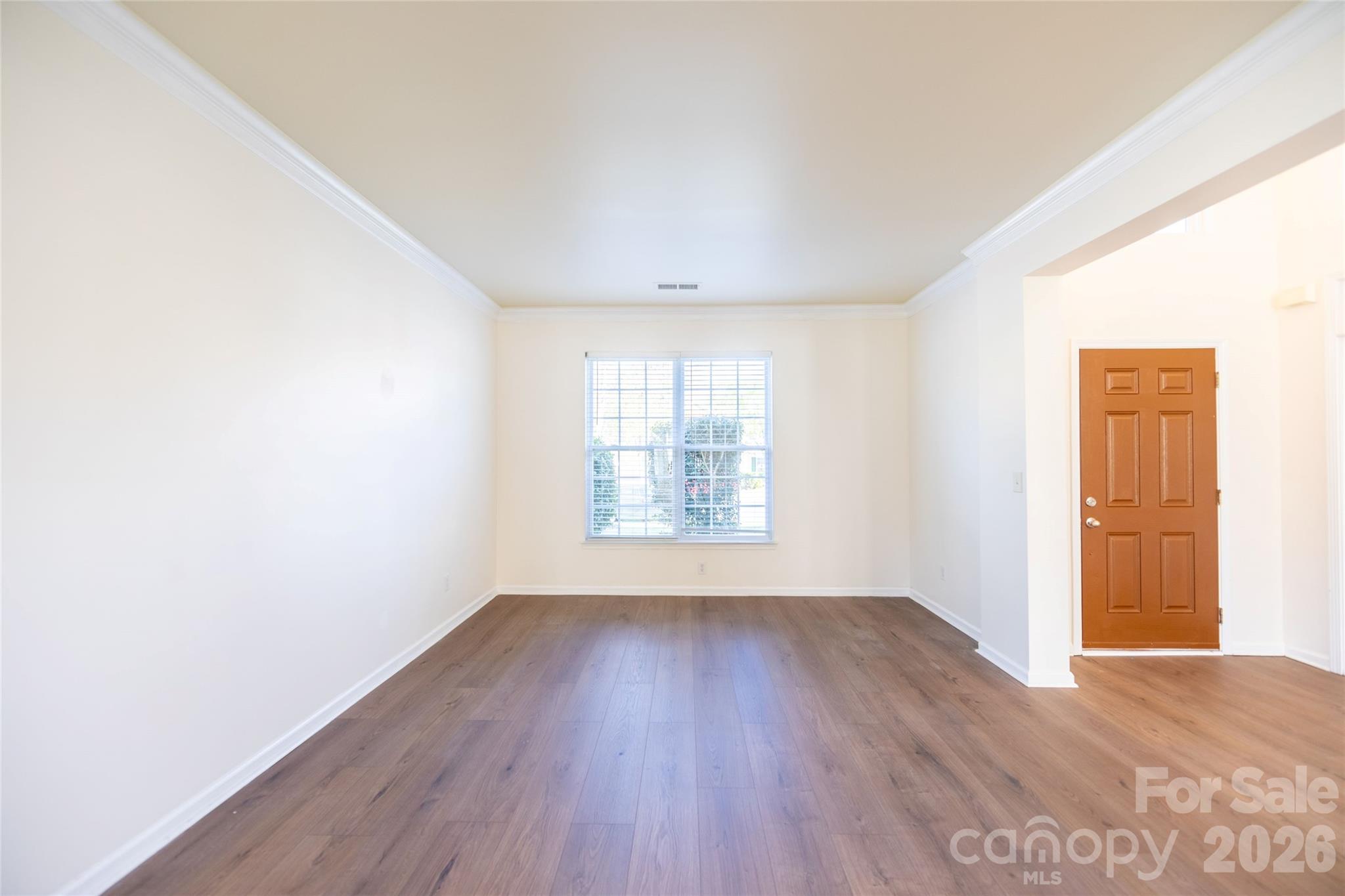 6002 Brook Valley Run Monroe, NC 28110 - Photo 6 of 32 an empty room with wooden floor and windows