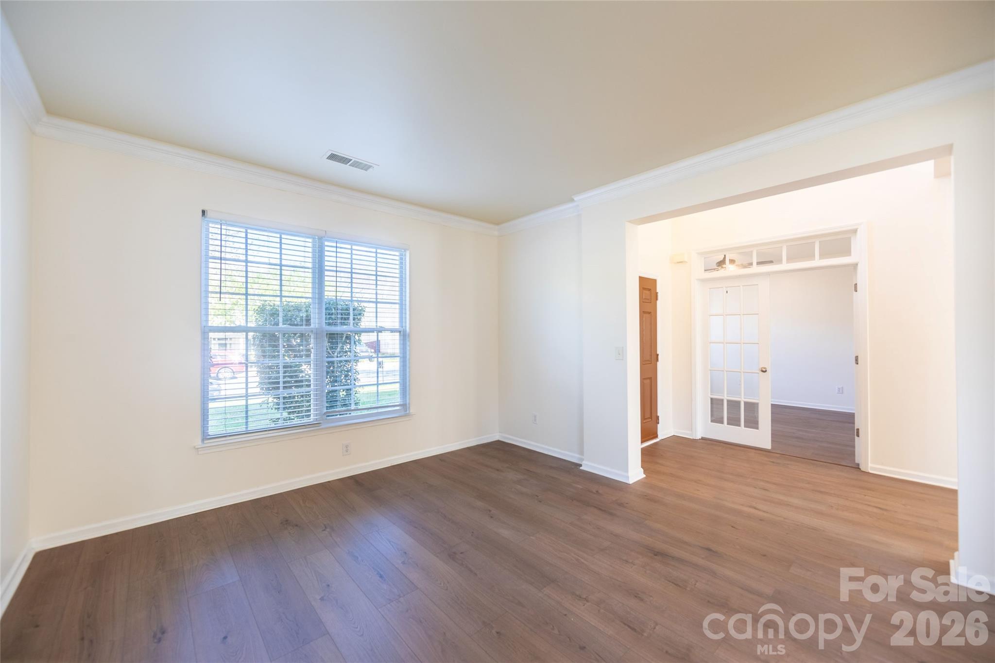 6002 Brook Valley Run Monroe, NC 28110 - Photo 7 of 32 an empty room with wooden floor and windows