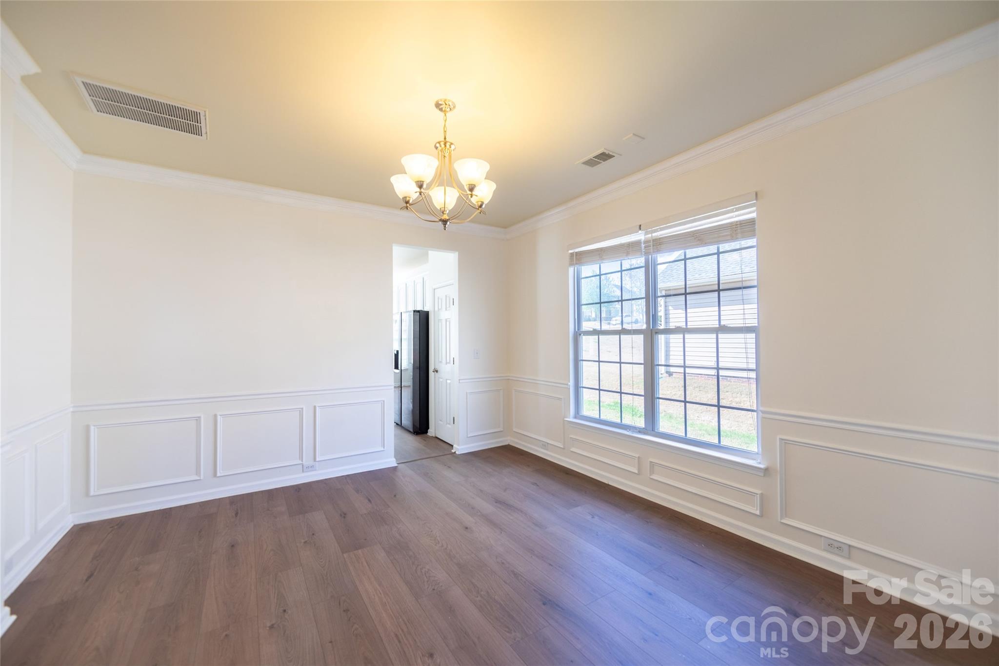 6002 Brook Valley Run Monroe, NC 28110 - Photo 8 of 32 an empty room with wooden floor and windows