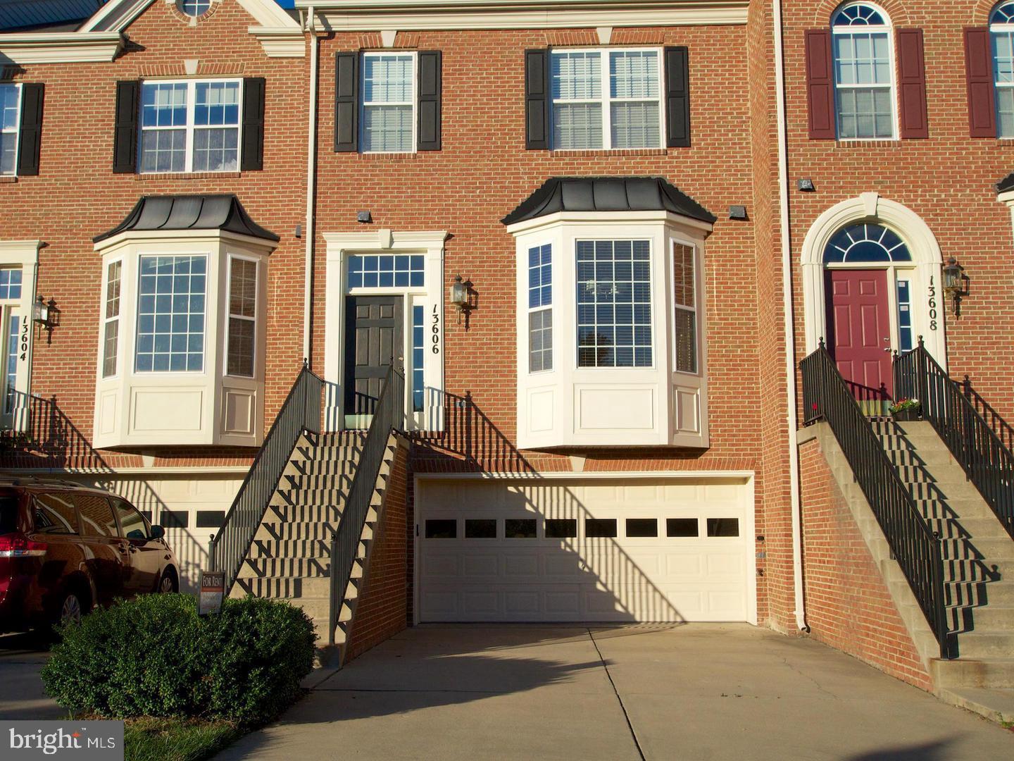 13606 Mills Farm Road Rockville, MD 20850 - Photo 1 of 18 a front view of a building with many windows