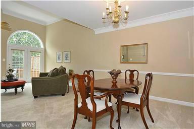 13606 Mills Farm Road Rockville, MD 20850 - Photo 3 of 18 a view of a dining room with furniture and a chandelier