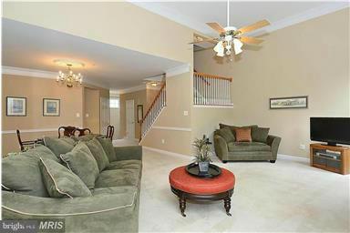 13606 Mills Farm Road Rockville, MD 20850 - Photo 5 of 18 a living room with furniture and a chandelier