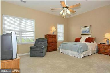 13606 Mills Farm Road Rockville, MD 20850 - Photo 10 of 18 a spacious bedroom with a bed and ceiling fan