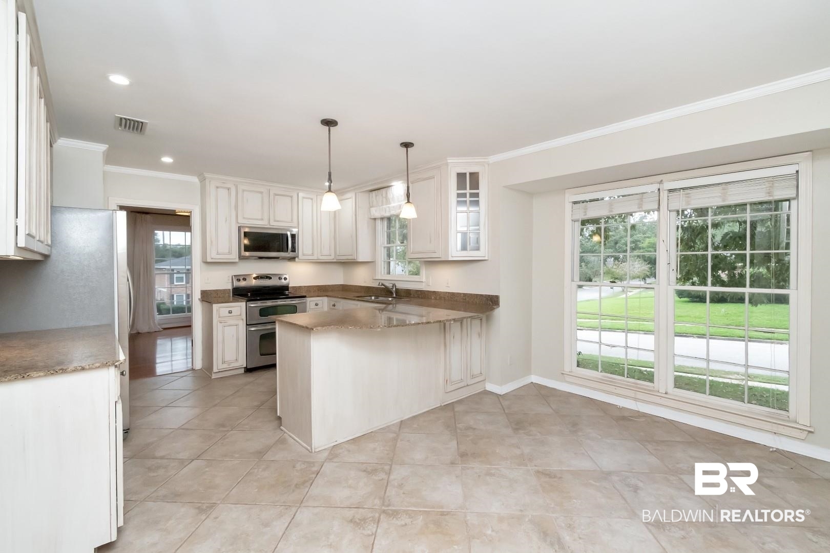 1229 West Chimney Top Drive Mobile, AL 36695 - Photo 16 of 36 Kitchen featuring white cabinetry, appliances with stainless steel finishes, and plenty of natural light